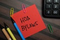 HOA Bylaws write on sticky notes isolated on Wooden Table Royalty Free Stock Photo