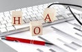 HOA written on a wooden cube on the keyboard with chart on grey background Royalty Free Stock Photo