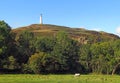 Hoad hill and historic 19th century monument in Ulverston with a horse grazing in a meadow