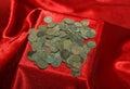 Hoard of antique coins on red cloth