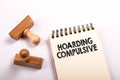 Hoarding Compulsive text written on a notebook. Stamps on a white background Royalty Free Stock Photo
