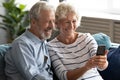 Hoary elderly woman taking selfie shot with happy old husband.