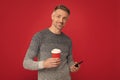 hoary man drinking coffee. male fashion model hold cup and smartphone. morning coffee.