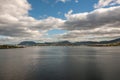 Hobart, Tasmania, Australia - December 13. 2009: Long shot at Tasman highway bridge over Derwent River with mountains under heavy Royalty Free Stock Photo