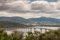 Hobart, Tasmania, Australia - December 13. 2009: Tasman highway bridge over Derwent River with mountains and far off neighborhoods Royalty Free Stock Photo