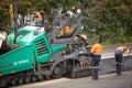 View of machinery and workers laying new bitumen on a suburban road near Hobart Royalty Free Stock Photo