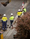 Machinery and workers repairing street surface