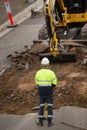 Machinery and workers repairing street surface