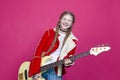 Hobbies and Music Concepts. Expressive Caucasian Guitar Player With Yellow Bass Guitar Posing In Fashionable Fur Red Jacket With