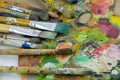 Hobbies, work, art and life in different colors on a palette with a brushes.Artist palette with a brush closeup.