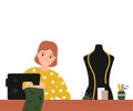 Hobby concept, girl at a sewing machine sews a clothes