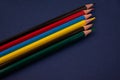 Bright multi-colored pencils on a blue background. Royalty Free Stock Photo