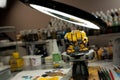 A hobby lamp over a yellow wargaming miniature