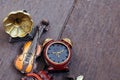 Miniature violin, clocks and gramaphone on wooden floor