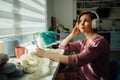 Hobby, mood and liesure concept. Woman relaxing with headphones while knitting tender dress with crochet in sunny day. Female Royalty Free Stock Photo