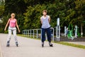 Young people casually rollblading together.