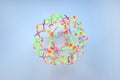 Hoberman sphere. Folding ball of rainbow colors on a light background.