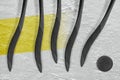 Five Hockey Sticks, Puck And Yellow Stripe