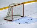 Hockey gates on ice close-up. Several pucks are visible near the goal and behind the net. Royalty Free Stock Photo