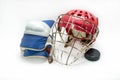 Hockey gloves,helmet and puck lay a white background isolated Royalty Free Stock Photo