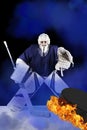 Hockey goalie stands in blue smoke ready to catch fiery puck