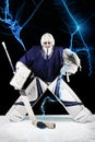 Hockey goalie stands UNDER BLUE FLASHES LIGHTNING ready to catch the puck.