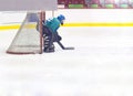 Hockey goalkeeper in helmet and gate