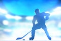 Hockey player skating with a puck in arena lighs Royalty Free Stock Photo