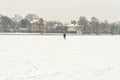 Hockey player trains alone on a frozen lake in heavy snow. people are not visible due to snow blur.