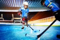 Hockey players challenging for puck on ice rink Royalty Free Stock Photo