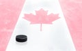 Hockey Puck and Canadian Flag on Ice With Copy Space