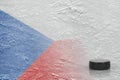 Hockey puck and the image of the Czech flag on the ice