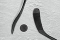 Two black sticks and ice hockey puck Royalty Free Stock Photo