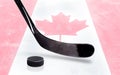 Hockey Stick and Puck With Canadian Flag on Ice