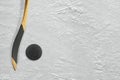 Hockey stick and puck on the ice Royalty Free Stock Photo