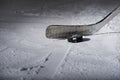 Hockey Stick and Puck on the Ice Rink Royalty Free Stock Photo