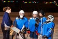 Hockey team listens to coach explaining game plan