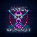 Hockey tournament neon sign with hockey sticks and puck and goalkeeper mask. Ice hockey competition logo, symbol design Royalty Free Stock Photo