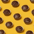 ÃÂ¡hocolate cupcakes or cookies pattern on a yellow background. Summer minimalism. Isometric flat lay. Top view. Food concept