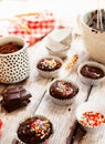 ÃÂ¡hocolate muffins with colorful pastry topping on a wooden table with ingredients