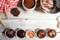 ÃÂ¡hocolate muffins with colorful pastry topping on a wooden table with ingredients