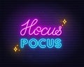 Hocus Pocus neon lettering on brick wall background