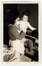 Vintage photo of a small girl with her mother, circa 1941