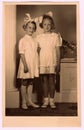 A vintage photo of the young girls - the first holy communion. Photo with colour tint, circa 1945