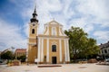 Hodonin, South Moravia, Czech Republic, 03 July 2021: Baroque white and yellow church of St. Lawrence at main square at summer
