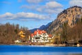 Hohenschwangau Castle, Alpsee lake, landscape view in spring, red maple fall foliage, Bavaria, Germany Royalty Free Stock Photo