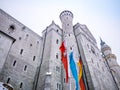 HOHENSCHWANGAU, GERMANY - 23 FEBUARY 2018: Neuschwanstein Castle in winter Close-up. Germany and EU flag.The destination famous ca