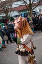 Parade participants in cow costumes and masks