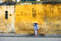 HOI AN, QUANG NAM, VIETNAM, April 26th, 2018:Vietnamese woman street seller In hoi an Vietnam in ancient town Hoi An with view of Royalty Free Stock Photo