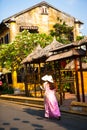 HOI AN, QUANG NAM, VIETNAM, April 26th, 2018: Vietnamese women wearing ao dai. Street view with old houses in Hoi An ancient town.